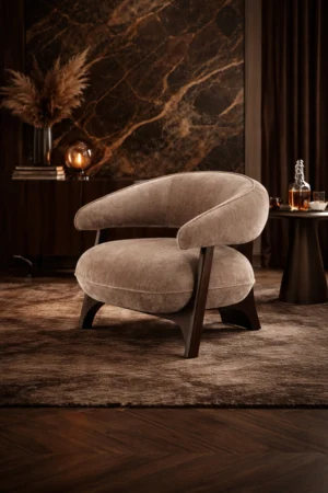 Sharelle Arden accent chair upholstered in taupe fabric with sculptural curved arms and solid wood legs.
