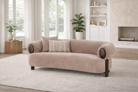 Sharelle Arden loveseat upholstered in taupe fabric with rolled arms and accent pillows in a contemporary living room.